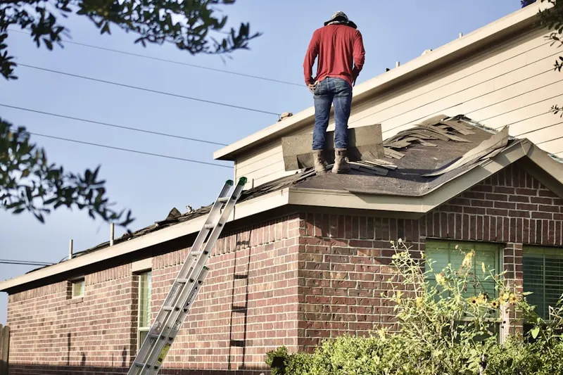 Professional roofer working on a residential roof in Doral Isles
